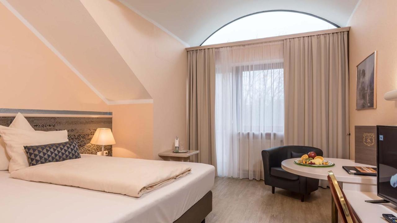 Zimmer mit Kingsize-Bett und Gartenblick.